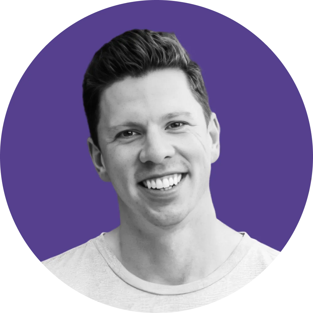 Smiling man with short dark hair in a circular headshot against a purple background.
