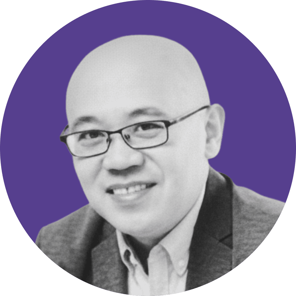 Bald man with glasses smiling confidently in a professional headshot.
