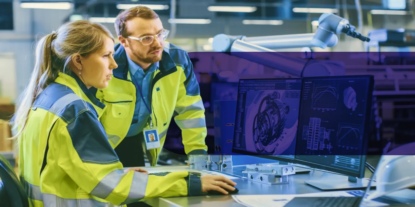 Engineers reviewing 3D technical designs on computer monitors