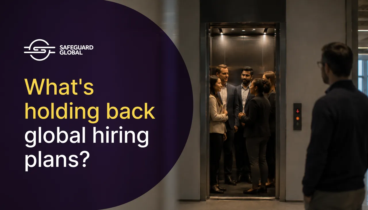 Business people in an elevator with text 'What's holding back global hiring plans?'.