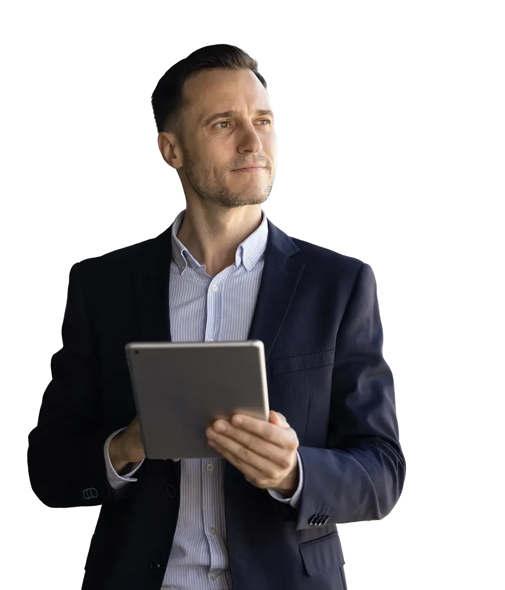 Professional man in a suit holds a tablet, looking thoughtfully into the distance.