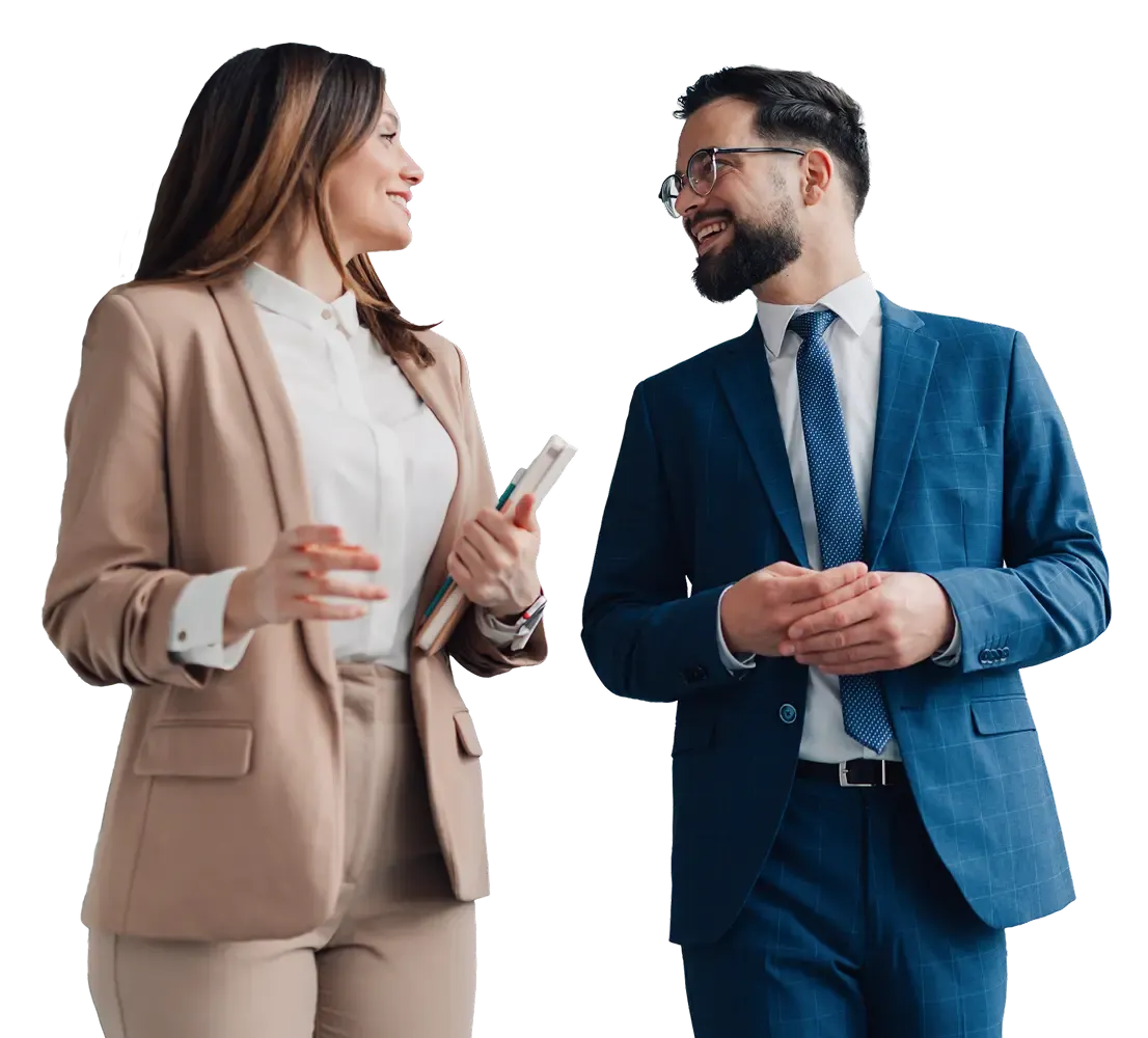 Two smiling business professionals, a man and a woman, conversing amicably.