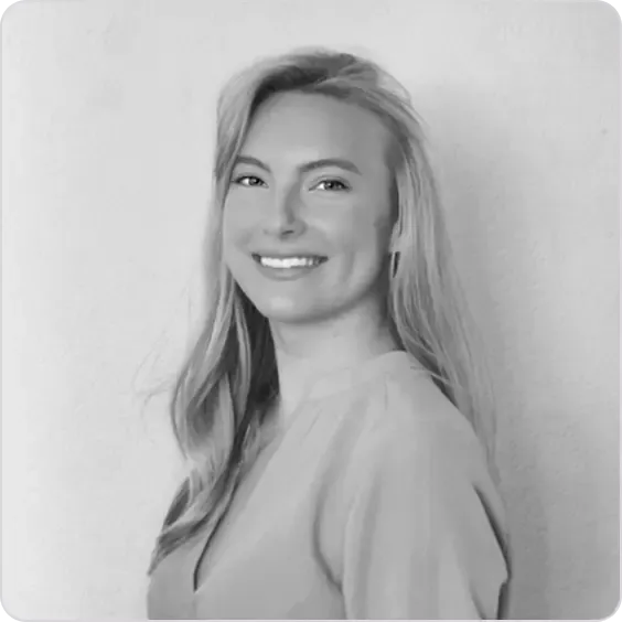 Smiling blonde woman with long hair looking slightly right in a professional headshot.