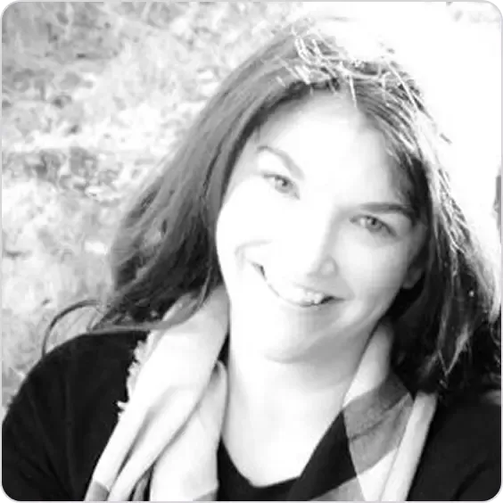 A smiling woman with dark hair and a light scarf looking directly at the viewer.